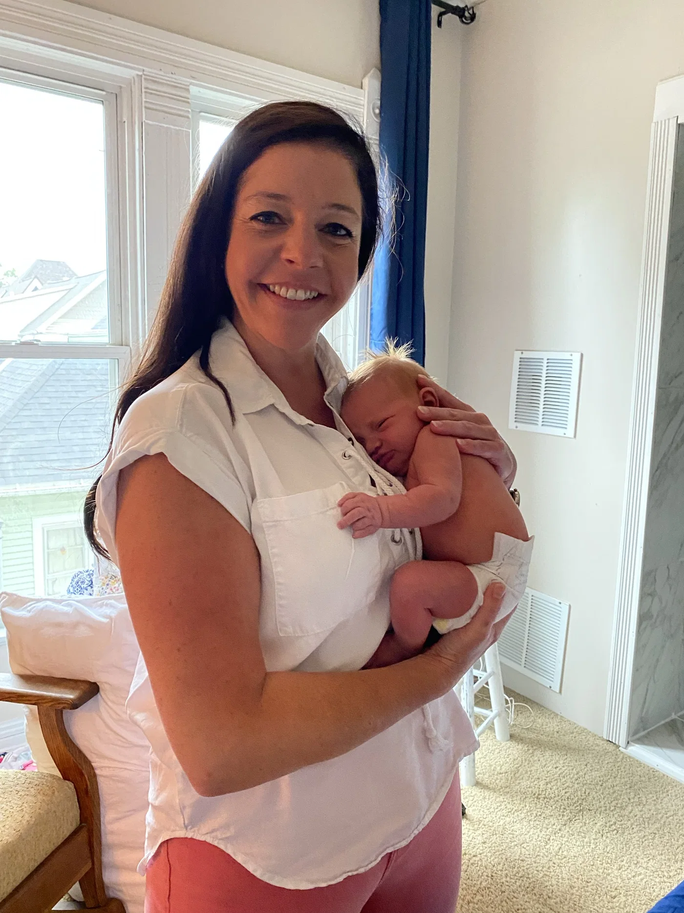 Julia Meyer holding a newborn after a home birth